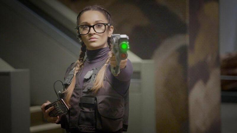 Agent L (Bessy Naidu) points a weapon in CITV's Spy School.