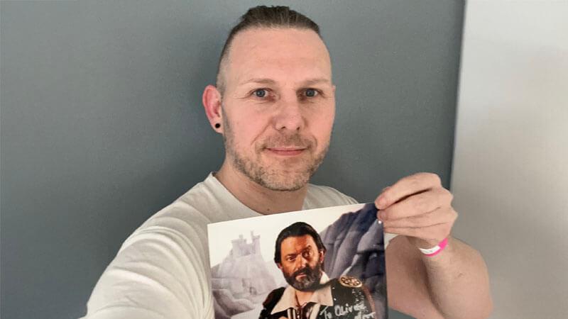 Oliver Duhl (Series 8, Team 7 Dungeoneer) holding an autographed picture of Hugo Myatt as Treguard
