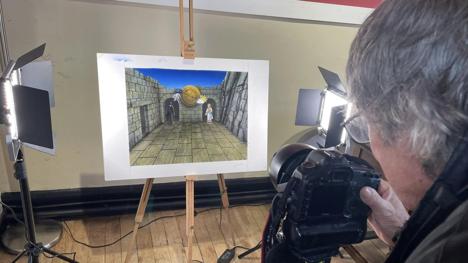Knightmare artist David Rowe takes a photograph of one of his new handpainted artworks