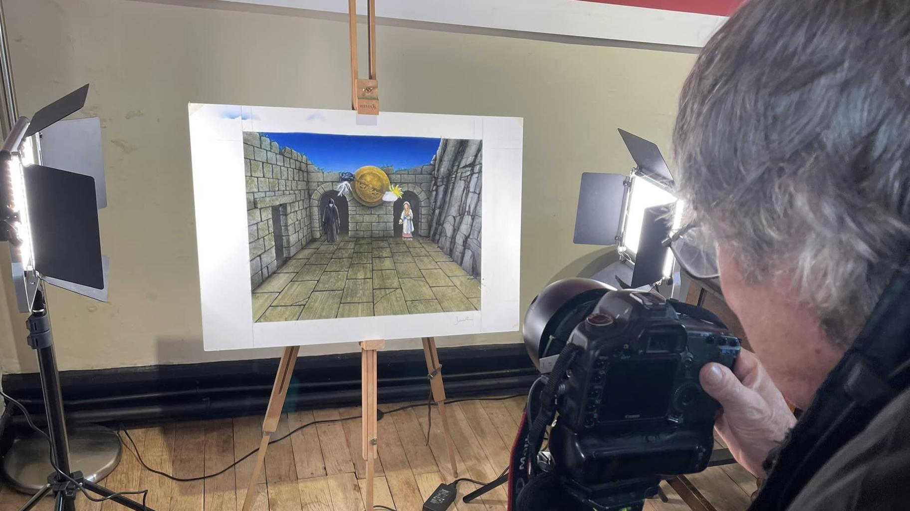 Knightmare artist David Rowe takes a photograph of one of his new handpainted artworks