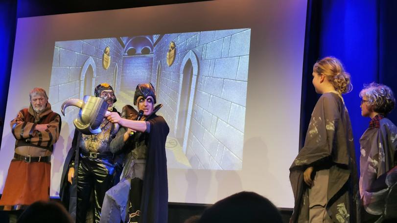 Lord Fear (Tom Bell) from Knightmare Live offers out the helmet as he poses a dilemma to the children on stage. At the Leicester Square Theatre, London.