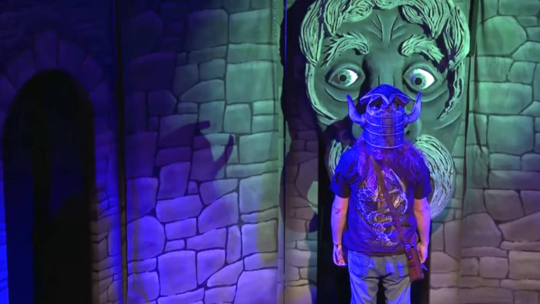 A dungeoneer talks to Olgarth in the Knightmare Live stage show.