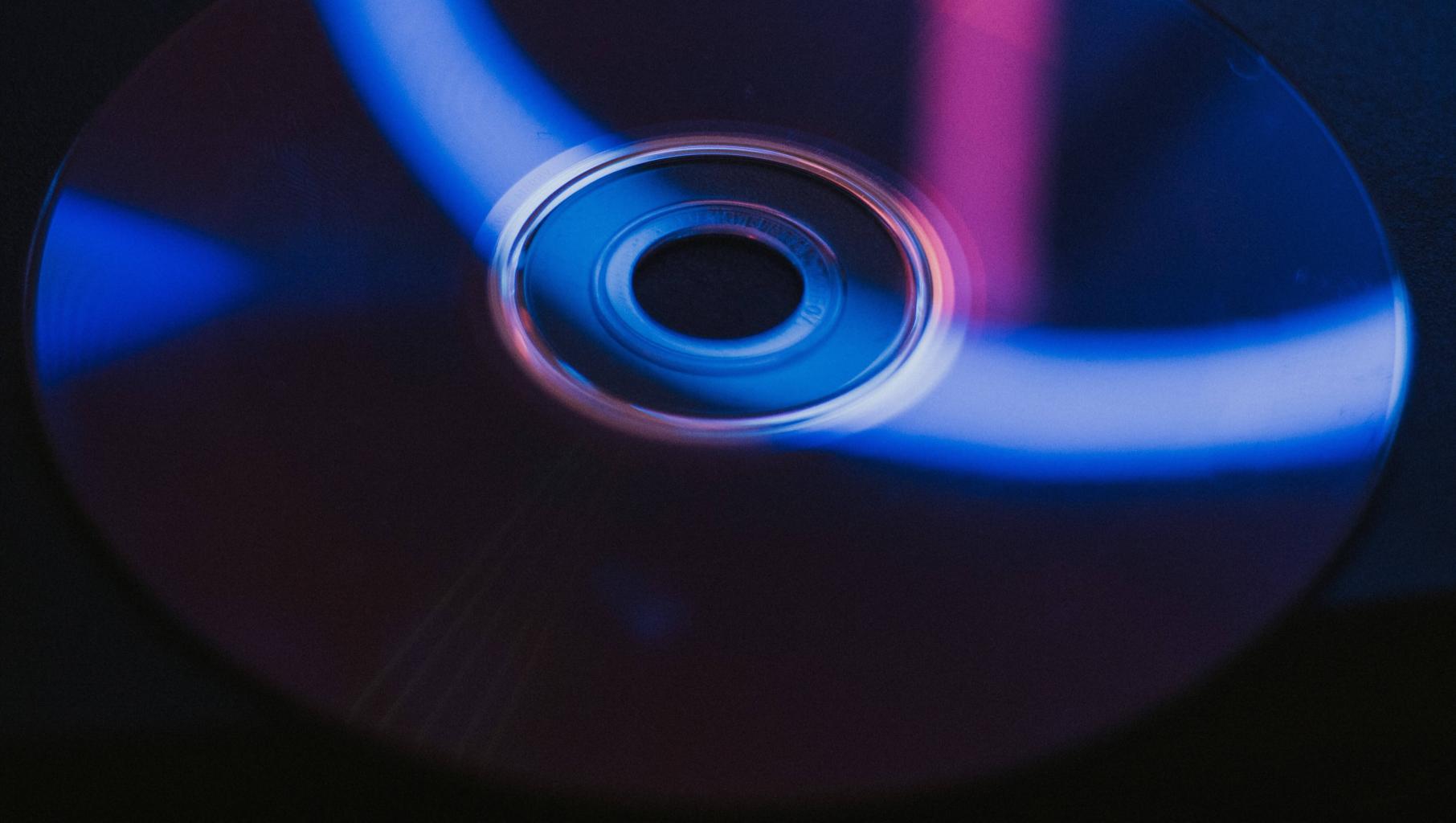 Blue and black DVD. Photo by Gio Bartlett on Unsplash.