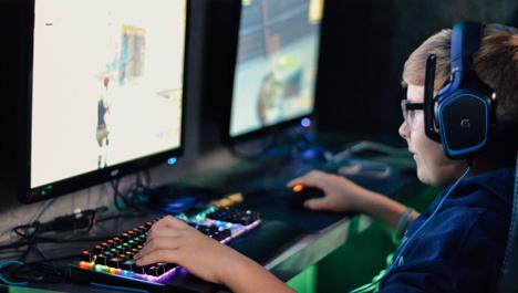 Young gamer with headset. Photo by Alex Haney on Unsplash.