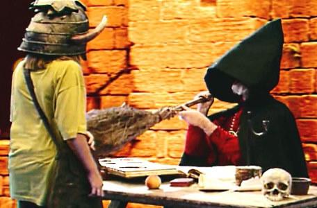 Knightmare Series 6 Team 6. Hordriss disguised as a witch pokes a broomstick at the dungeoneer.